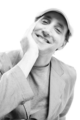 Andrew Bleckner, smiling, chin resting on his hand